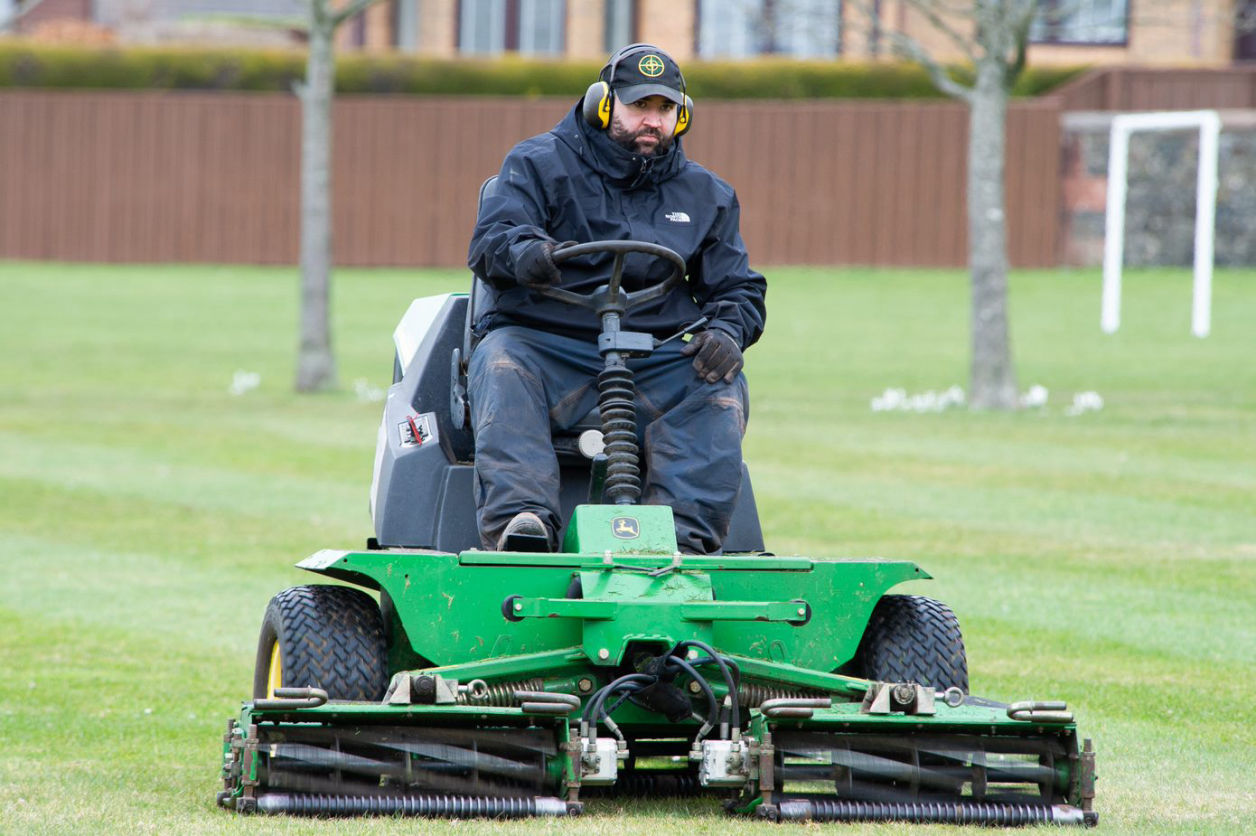 Man on Grass Cutting Machine